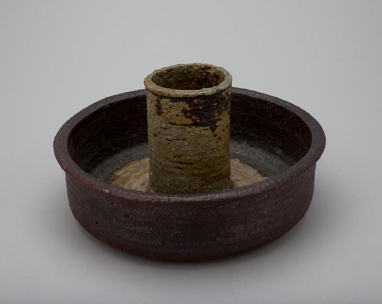 A CERAMIC CANDLESTICK.