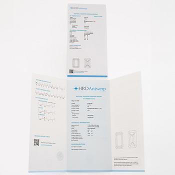 An 18K white gold ring set with an emerald-cut diamond and two step-cut emeralds.