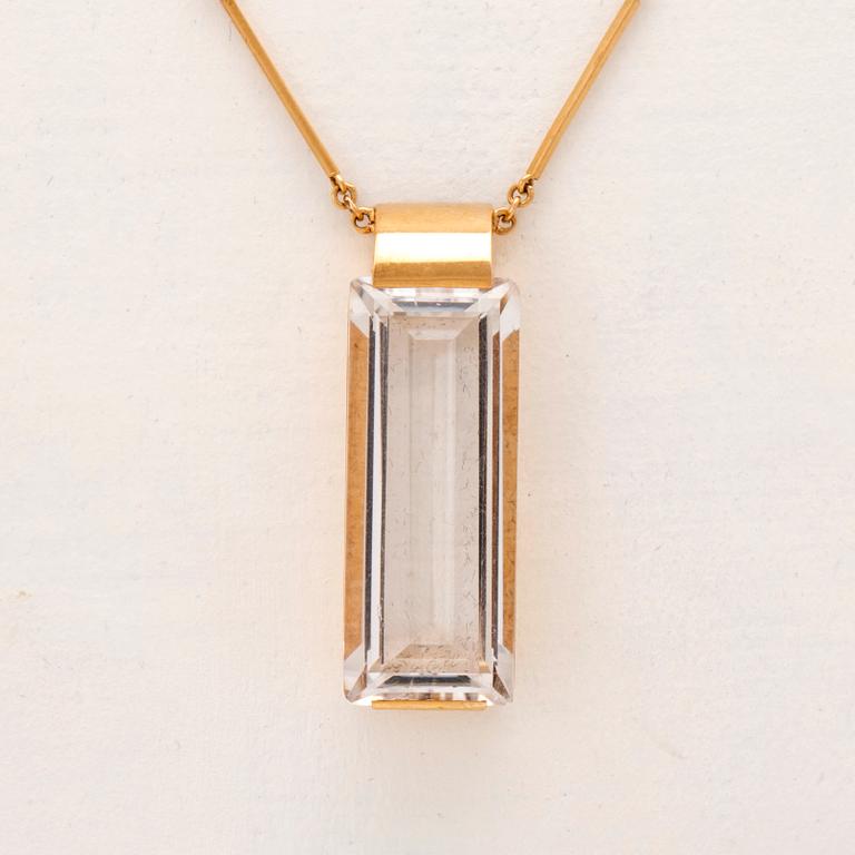 An 18K gold necklace set with a step cut rock crystal quartz by Ateljé Stigbert 1943.