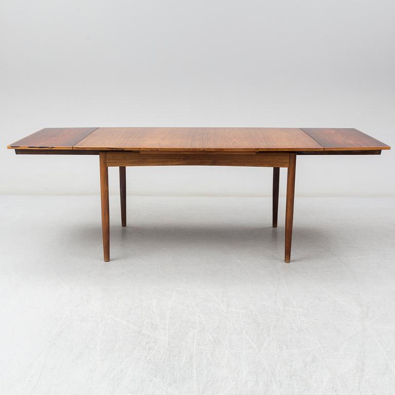 A Danish rosewood dining table, six chairs and a pair of armchairs, 1950's/60's.