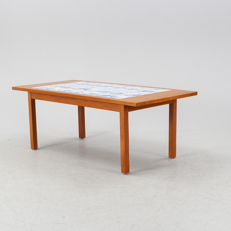 A teak coffee table with inlaid tiles. Second half of the 20th Century.