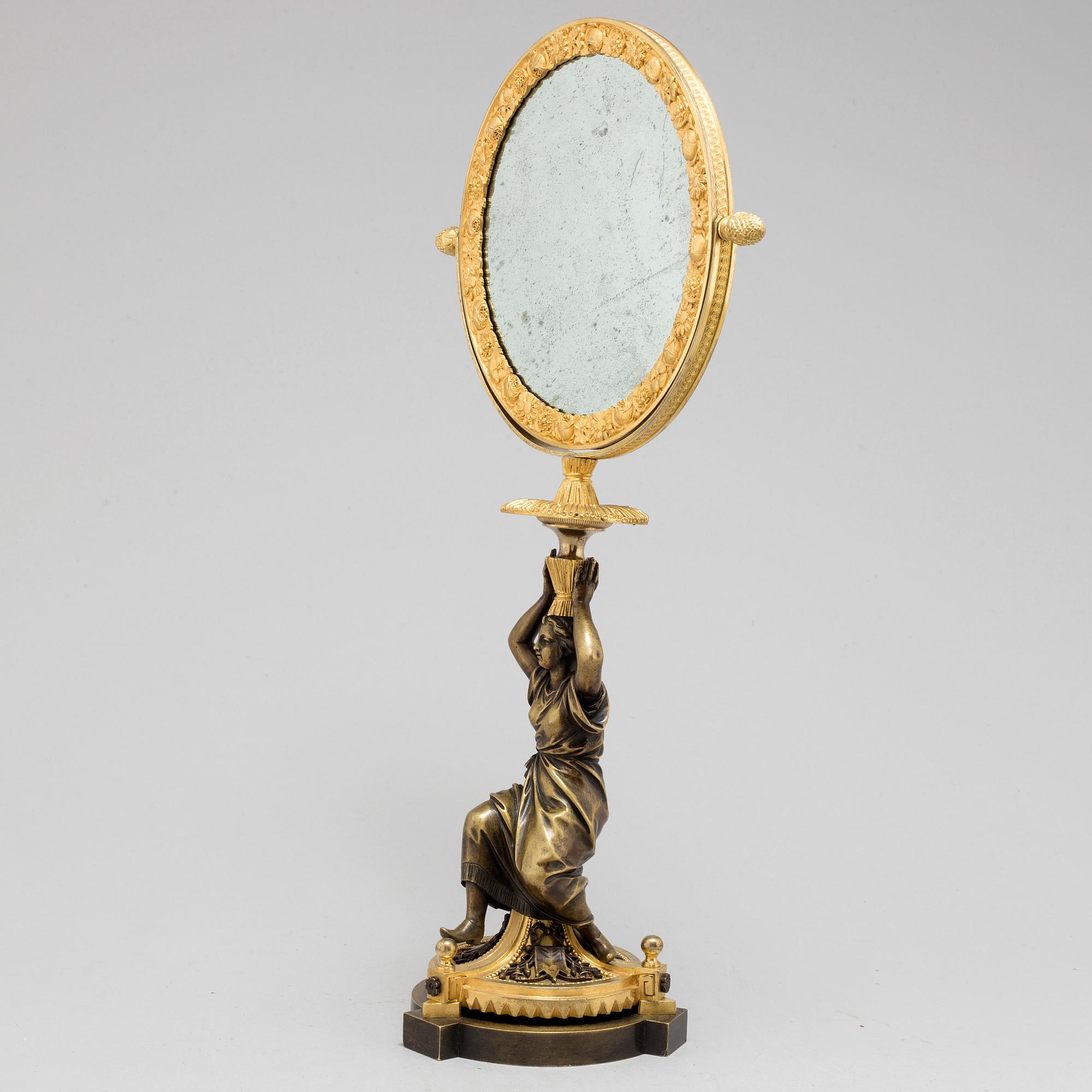 AN EMPIRE ORMOLU TABLE MIRROR, first half of the 19th century.