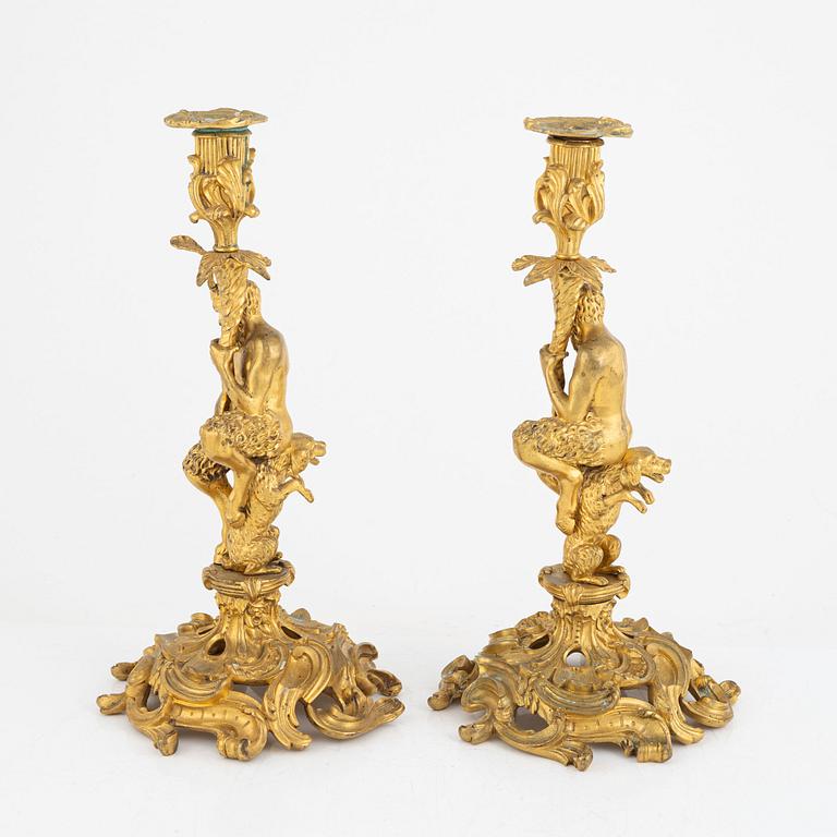 A pair of French gilt-bronze Louis XV-style candlesticks, late 19th century.