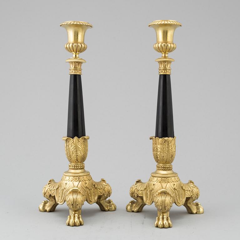 A pair of Empire style candlesticks, 20th Century.