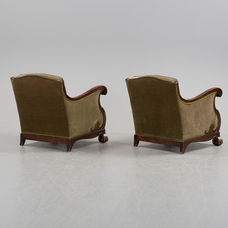 A pair of armchairs and a table, mid 20th century.