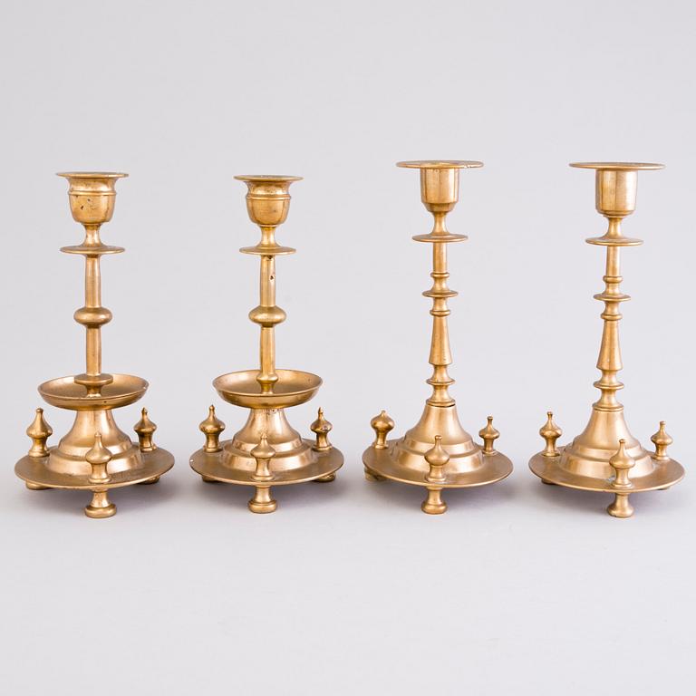 Four Russian brass candlesticks, two marked Pimenov, around 1900.