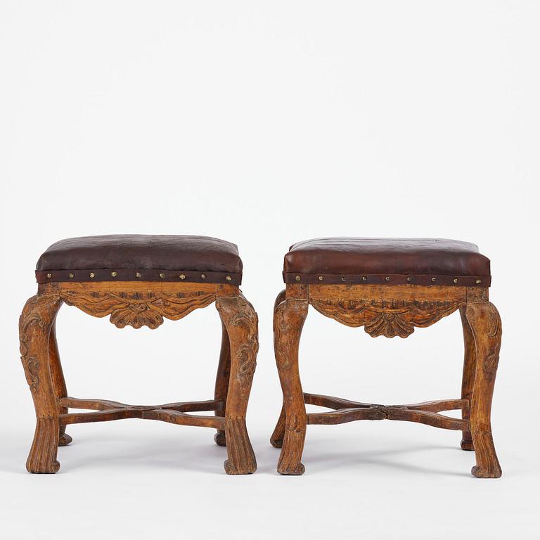 A pair of carved stools in the manner of Jonas Granberg, Jämtland, Sweden, mid 18th century.