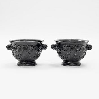 A pair of cast-iron urns.