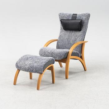 A 'Delta Adventure' wingback armchair and foot stool from Brunstad AS, Norway.