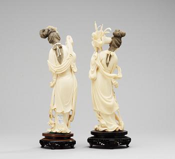 A pair of 20th Century Chines ivory figures.