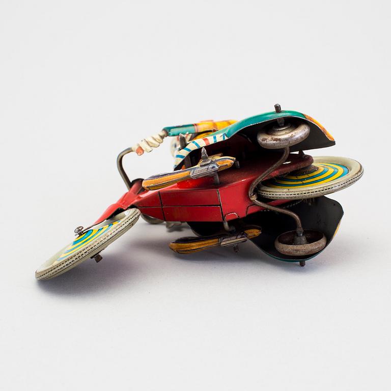 A tinplate Technofix bicycling clown Germany c. 1950.