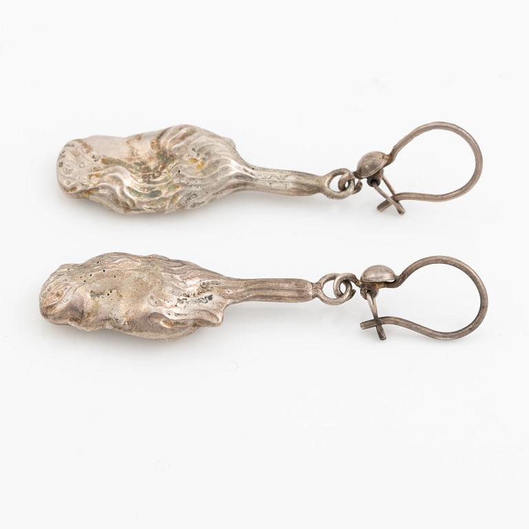 A pair of silver earrings, likely Olle Ohlsson.