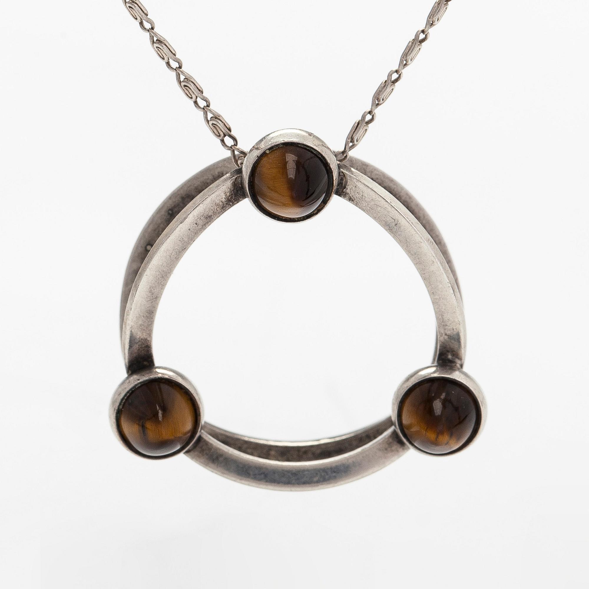 Elis Kauppi, a silver and tiger's eye pendant, Kupittaan Kulta, Turku. With chain in silver.