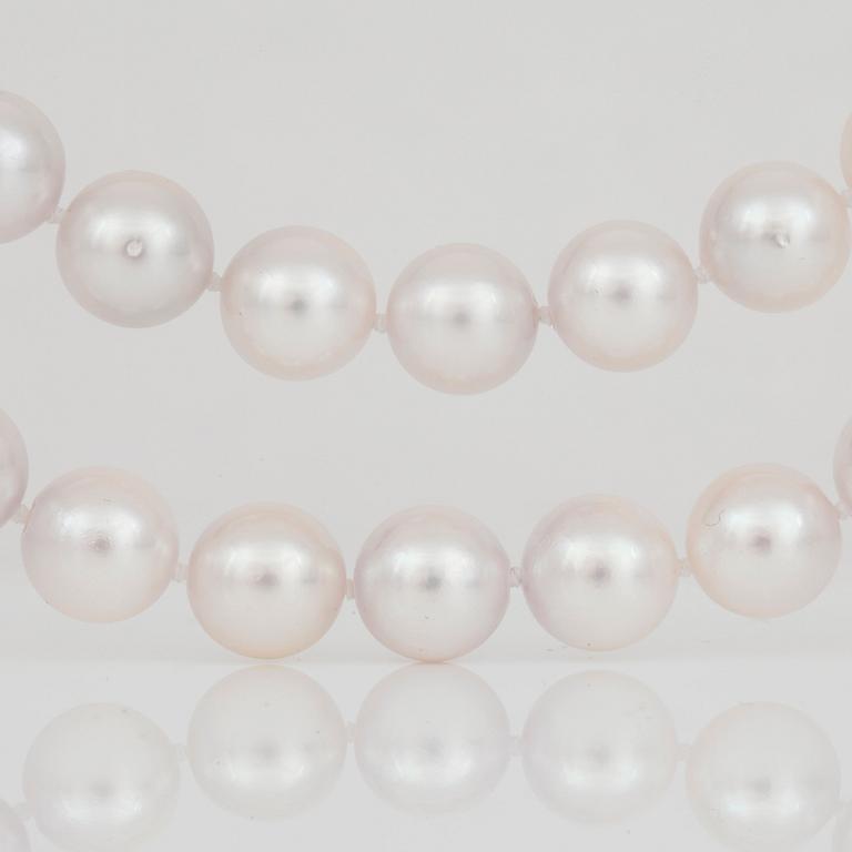 A cultured saltwater pearl necklace. Clasp set with brilliant-cut diamonds.