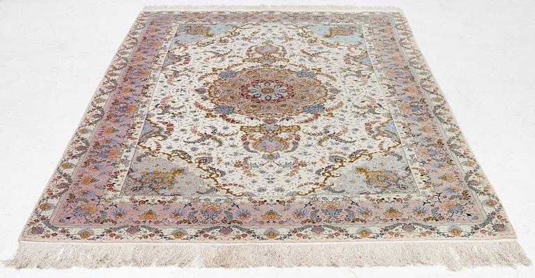 A Tabriz carpet north west Persia, part silk, c. 314 x 197 cm.