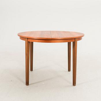 A 1960s walnut dining table.