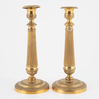 A pair of gilt brass Empire candlesticks, early 19th century.