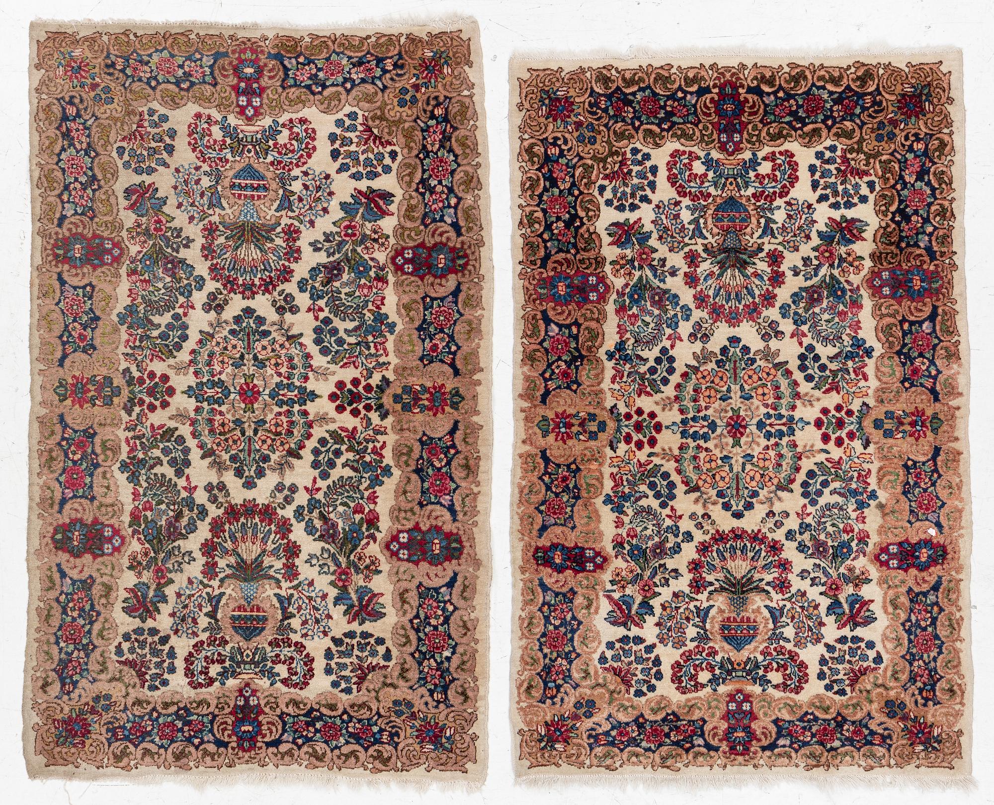 A pair of similar Kirman rugs, south Persia, c. 147 x 94 and 154 x 96 cm.