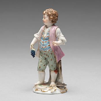 242. A Meissen figure of a young boy with grapes, 1890's.