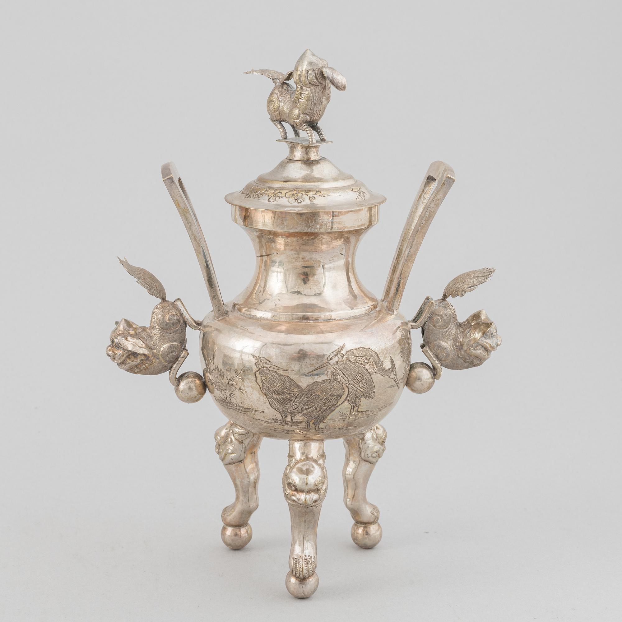A Chinese metal incense burner in a wooden display case 20th century.