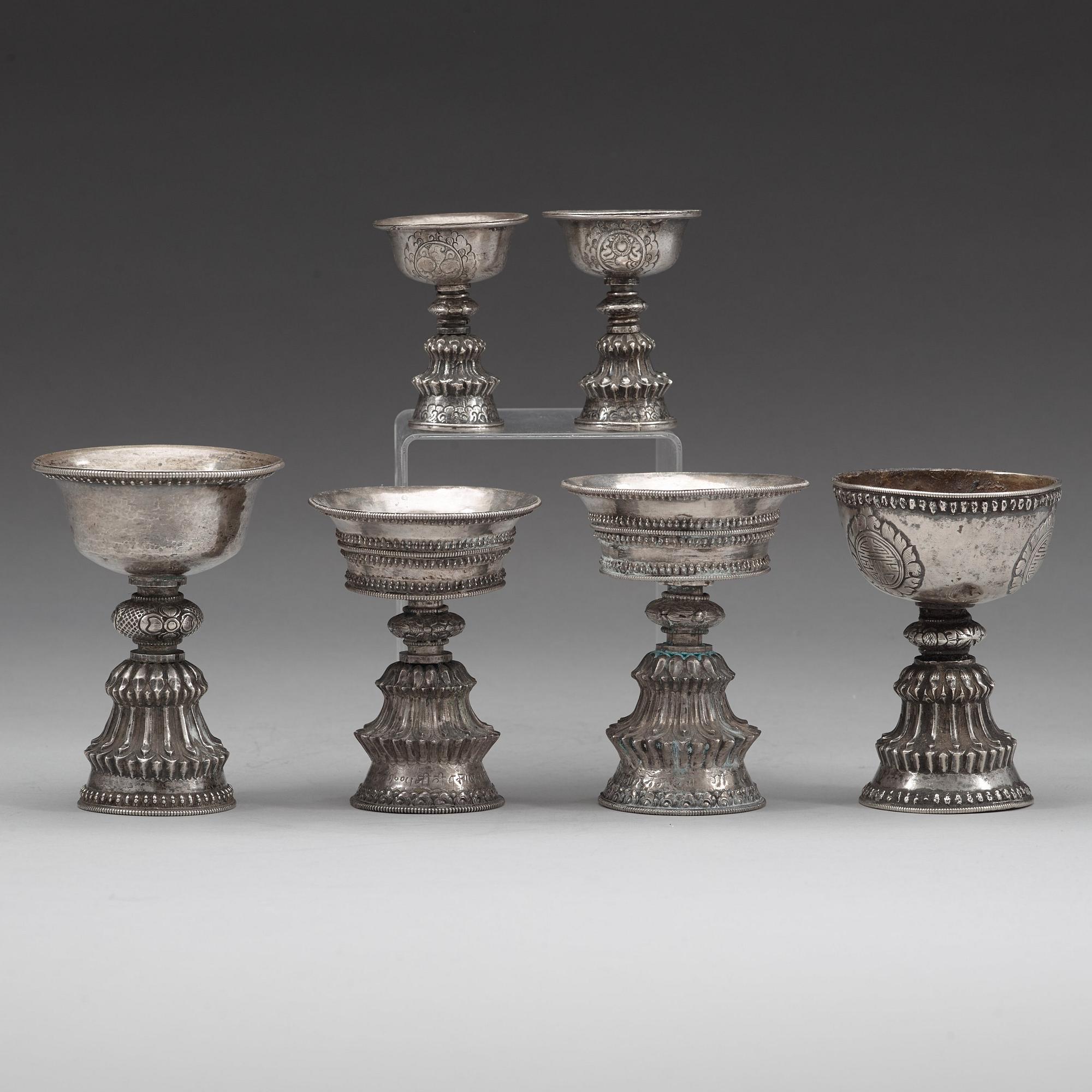 A group of six Tibetan silver/silvered Butter lamps, 19th Century.