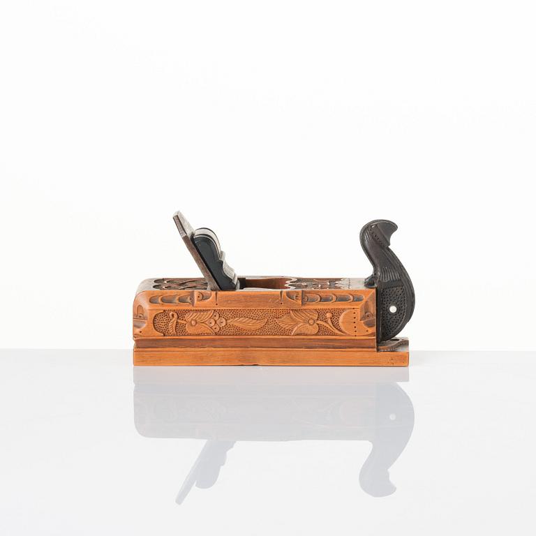 A Swedish carved ebony, boxwood and bone plane, dated 1748.