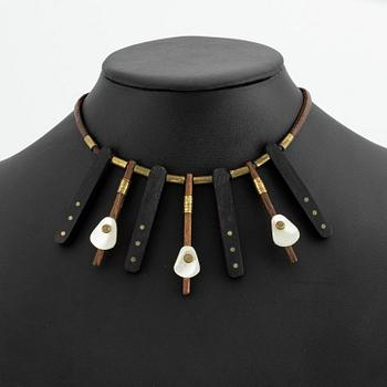 Vivianna Torun Bülow-Hübe, a necklace, wood, leather, mother-of-pearl and brass, most likely 1950's.