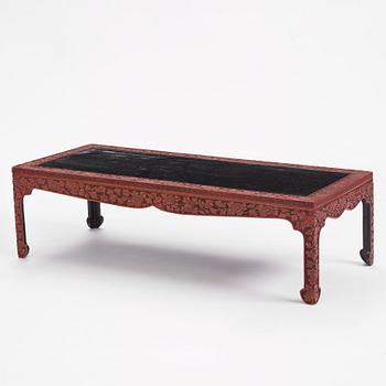 A carved lacquered table, early 20th Century.