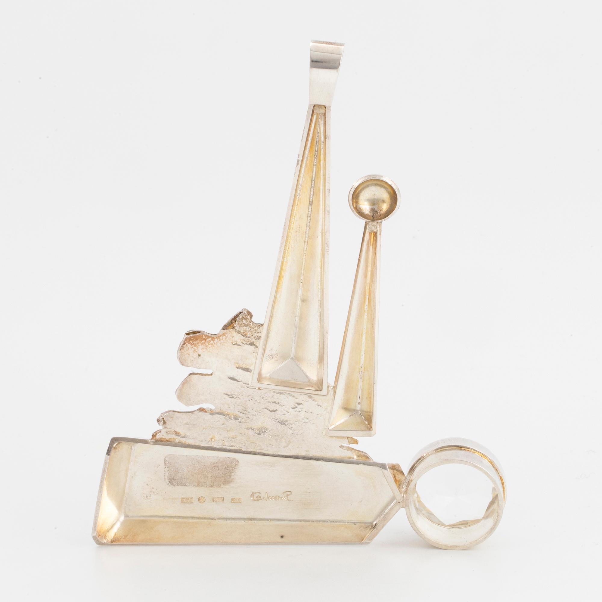 A Rolf Karlsson sterlingsilver + 18K gold and round faceted rock crystal pendant.