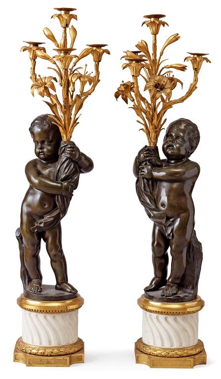 A pair of Louis XVI-style 19th century gilt and patinated bronze marble four-light candelabra.