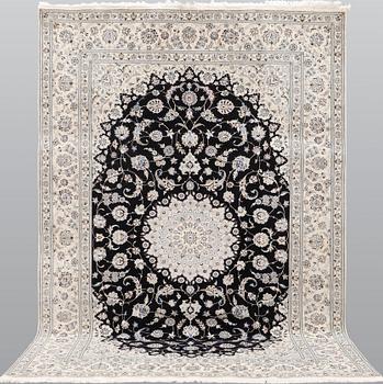 A Nain part silk carpet, 310 x 204 cm.