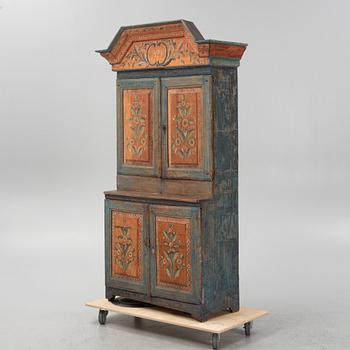 A painted cabinet, dated 1825.