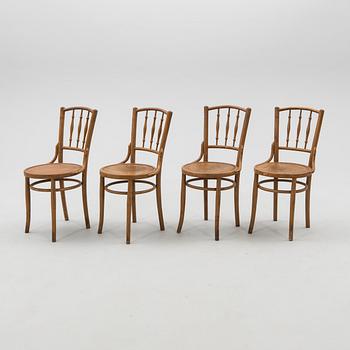 A set of four chairs from the first half of the 20th century.