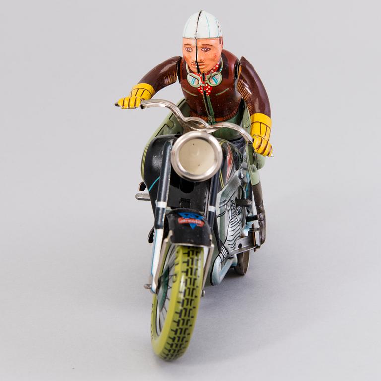 ARNOLD, a Mac 700 motorcycle, Germany, 1950's and a Joustra "Gigi" figure France 1950s. Both in original boxes.