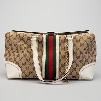 A Gucci canvas and leather hand bag.