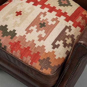 A pair of Artwood leather easy chairs.