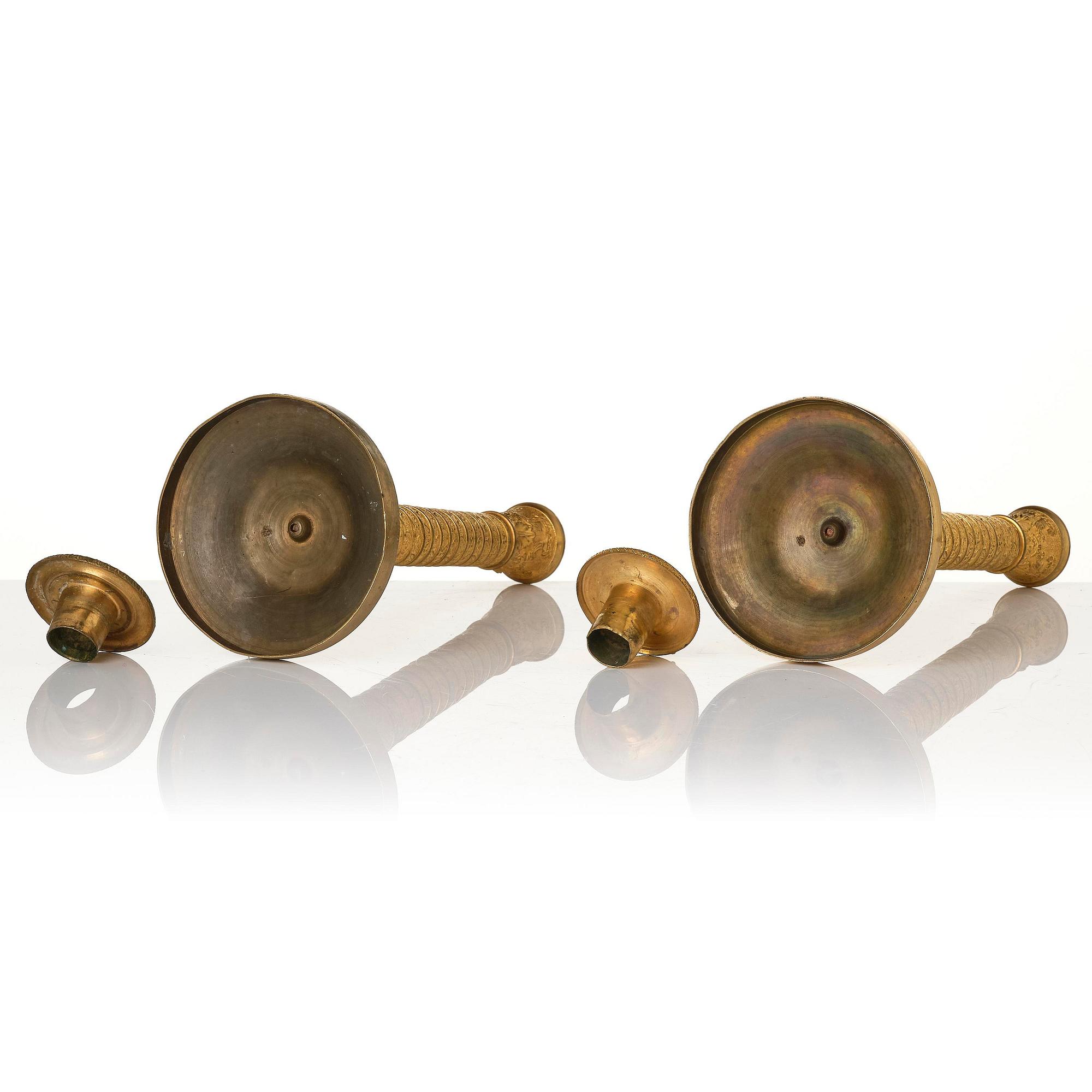 A pair of French Empire ormolu candlesticks, early 19th century.