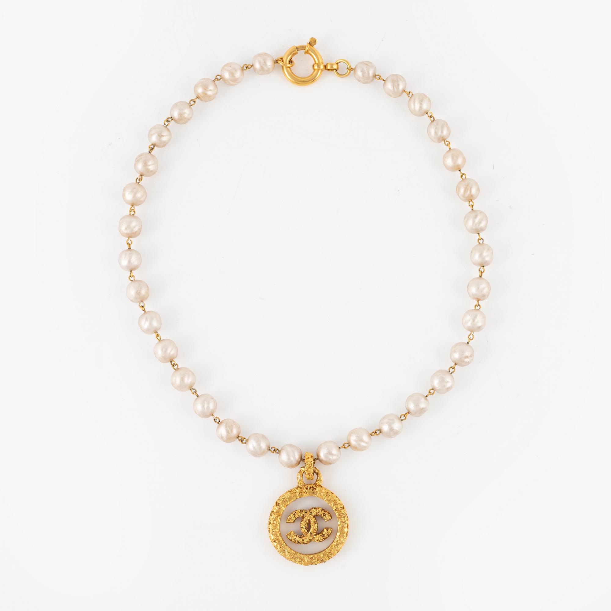 Chanel, A imitation pearl necklace with gold plated CC-charm, 1993.
