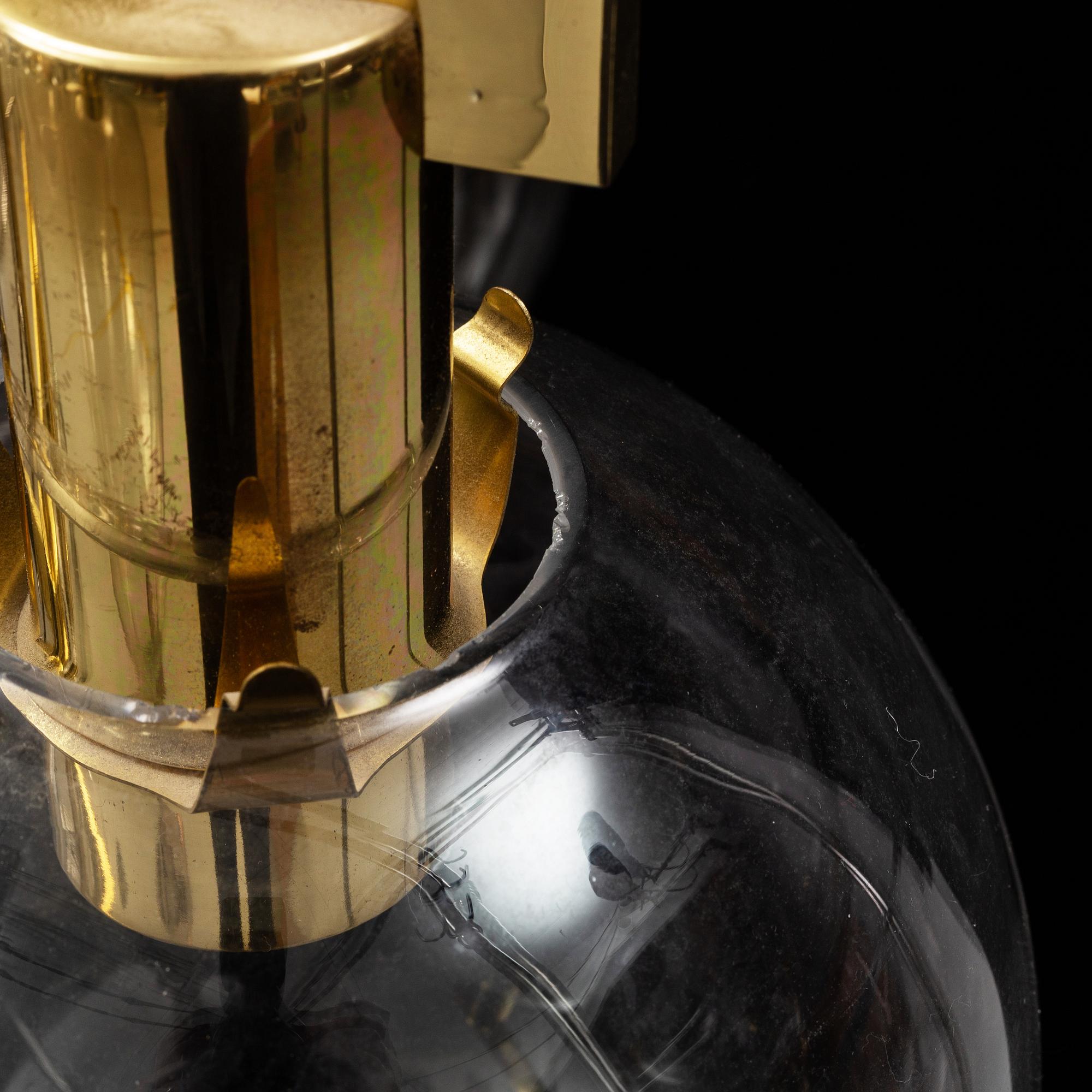 A brass chandelier with glass globes by Hans Agne Jakobsson, Markaryd.