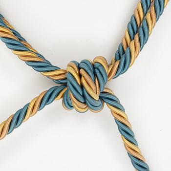 A set of four petroleum and gold curtain tiebacks from Declerq, Paris.