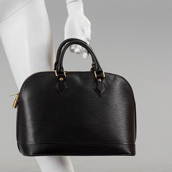 A black epi "Alma" handbag and keyholder by Louis Vuitton.