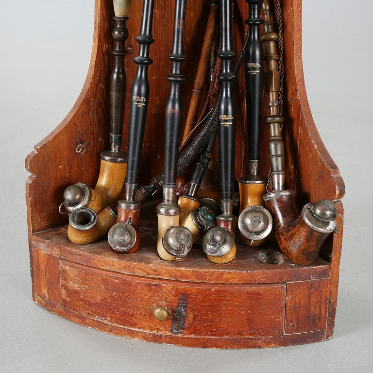 A 19th century pipe-rack with ten pipes and accessories.