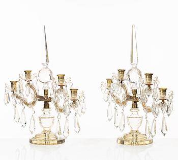 A pair of brass and glass canelabras, first half of the 20th century.