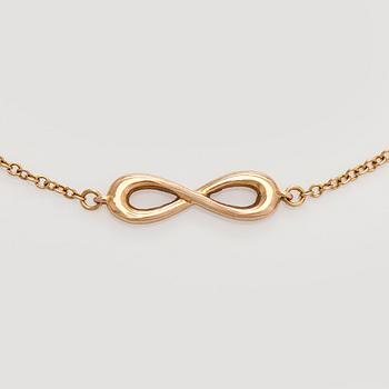 Tiffany & Co, an 18K gold 'Infinity Endless' bracelet.