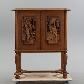 A finnish oak cupboard, signed E. Hallanvaara and dated 1946.