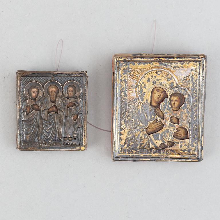 Two Russian 19th century travle icon, oklad in silver and parce-gilt, one with assayer mark AA 1890.