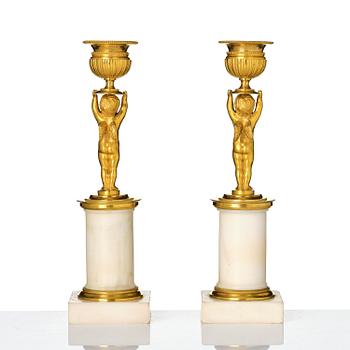 A pair of late Gustavian white marble and ormula candlesticks.