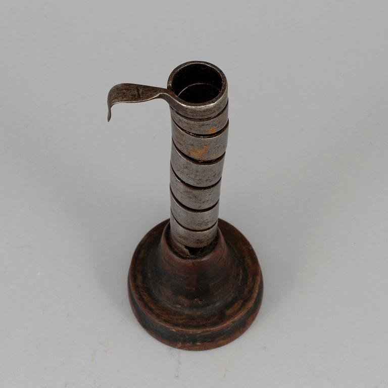 An 18th century wood and iron candlestick.