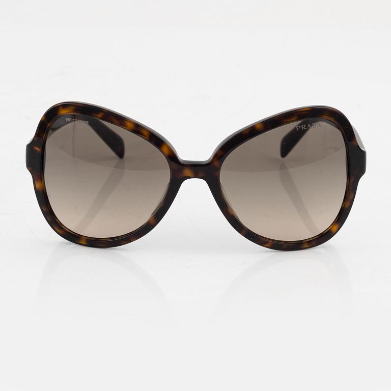 Prada, a pair of tortoise color sunglasses.