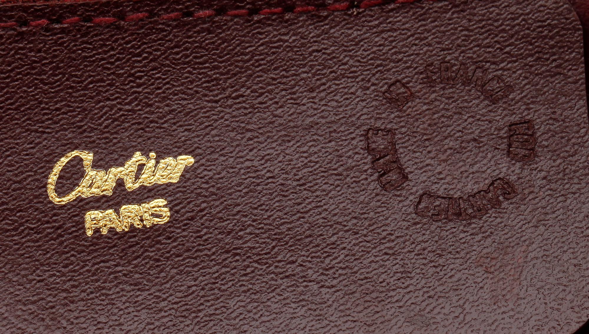 A bordeaux coloured leather weekendbag by Cartier.